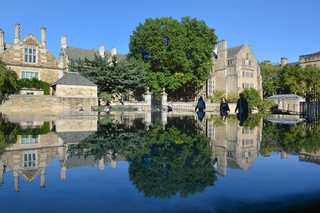 Yale building reflected in a still pool of water